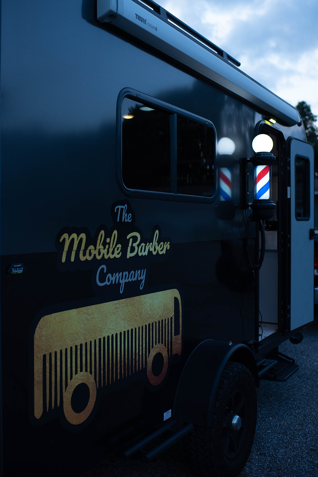 the mobile barber company truck and logo